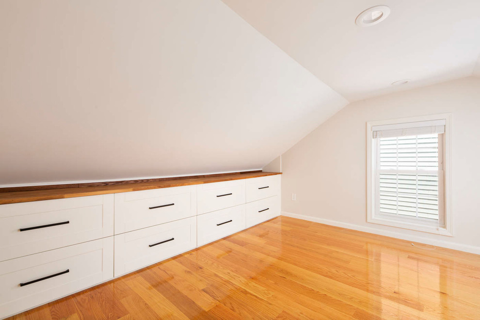 Photo of a modern guest bedroom in Boston with grey walls and light hardwood floors.