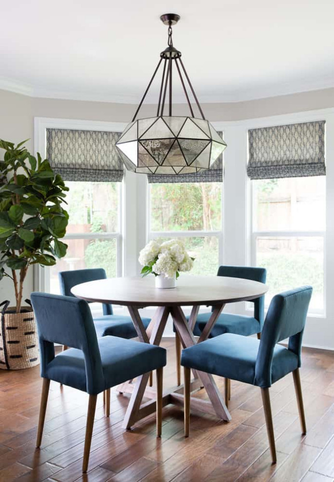 Inspiration for a mid-sized timeless medium tone wood floor enclosed dining room remodel in Austin
