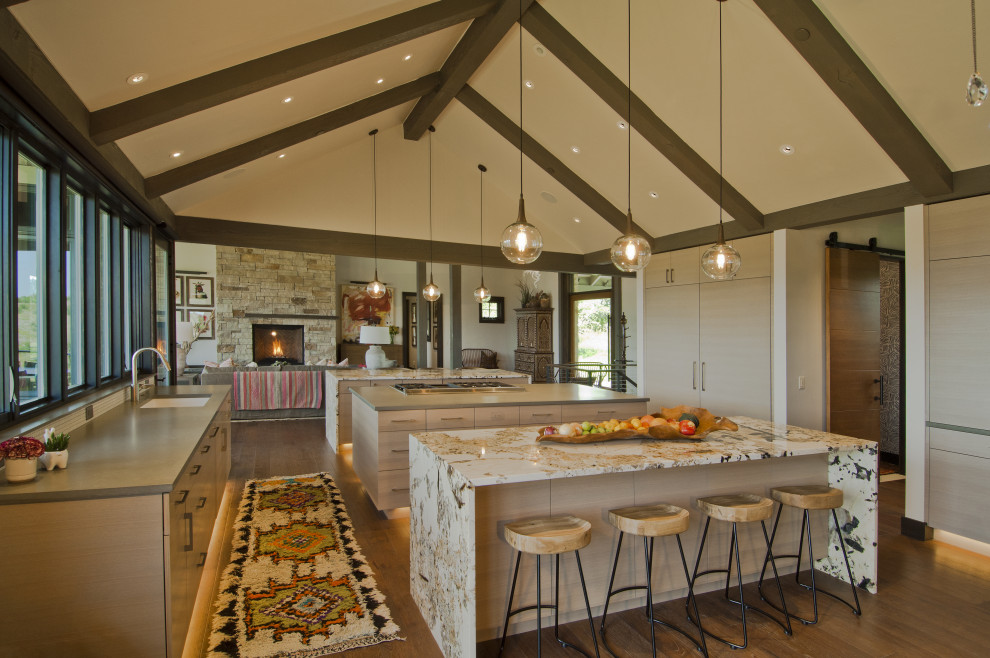 Exempel på ett stort modernt kök, med en undermonterad diskho, släta luckor, beige skåp, integrerade vitvaror, mellanmörkt trägolv, flera köksöar och brunt golv