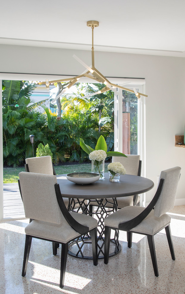 Photo of a small contemporary dining room in Miami with white walls and beige floor.