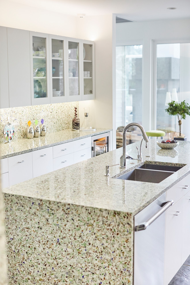 Inspiration for a mid-sized contemporary galley separate kitchen in New York with an undermount sink, flat-panel cabinets, white cabinets, recycled glass benchtops, green splashback, glass sheet splashback, stainless steel appliances, slate floors, with island and blue floor.