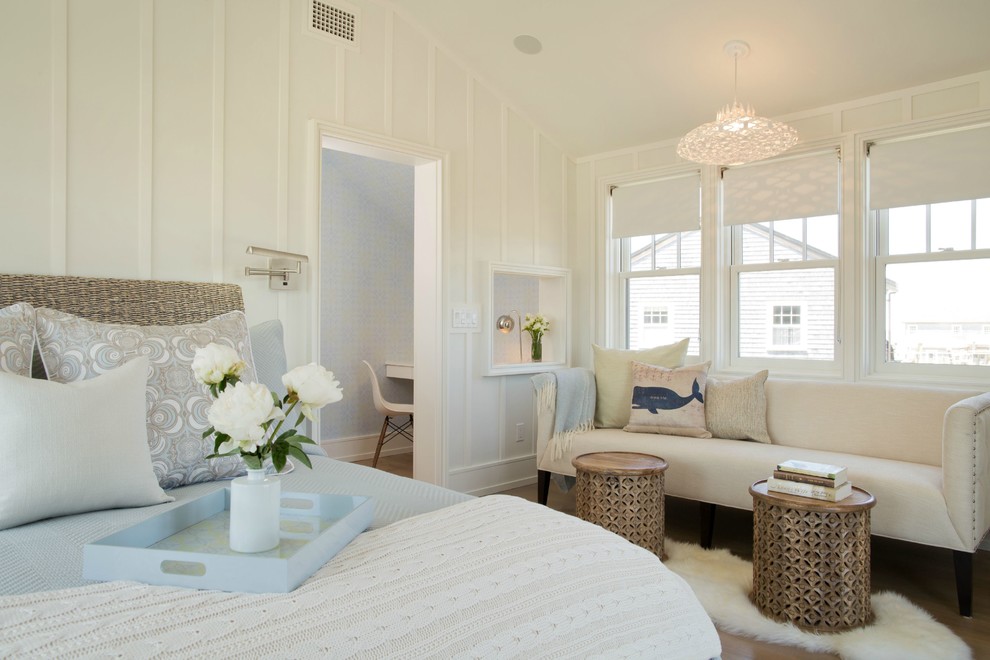 Design ideas for a large beach style master bedroom in Boston with white walls and medium hardwood floors.