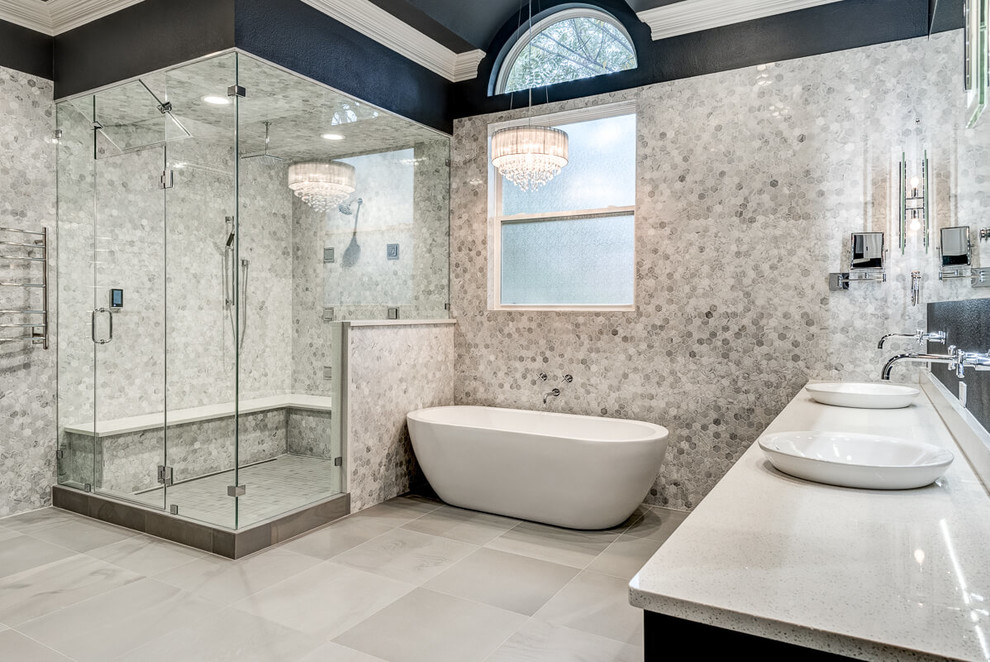 Large contemporary master bathroom in Dallas with raised-panel cabinets, dark wood cabinets, a freestanding tub, a corner shower, a two-piece toilet, gray tile, marble, grey walls, porcelain floors, a vessel sink, solid surface benchtops, grey floor and a hinged shower door.
