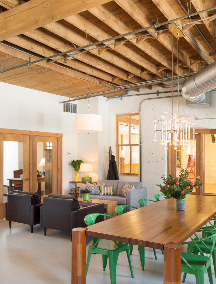 Inspiration for an industrial open concept living room remodel in Milwaukee with white walls