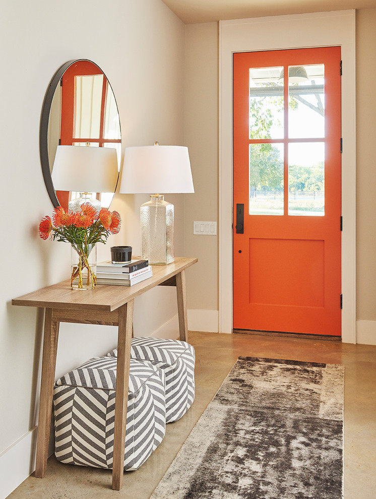 Design ideas for a transitional front door in Dallas with concrete floors, a single front door, an orange front door, beige walls and beige floor.