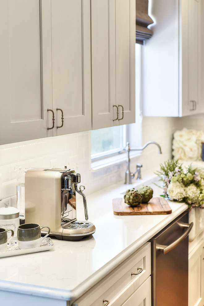 Inspiration for a large transitional l-shaped medium tone wood floor eat-in kitchen remodel in Jacksonville with a farmhouse sink, shaker cabinets, quartz countertops and an island