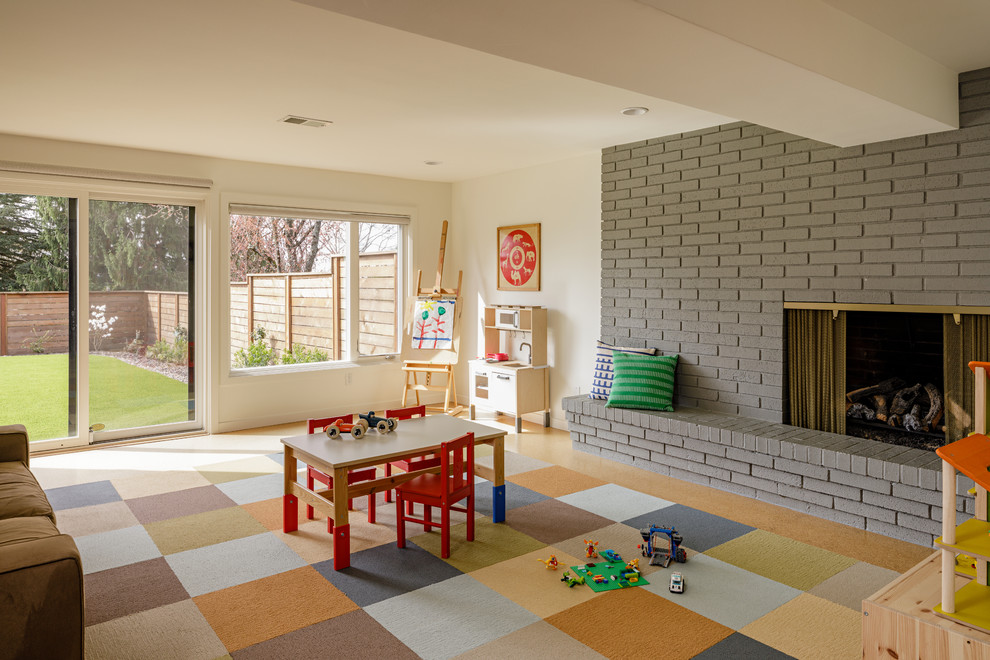 Inspiration for a midcentury gender-neutral kids' room in Portland with white walls.