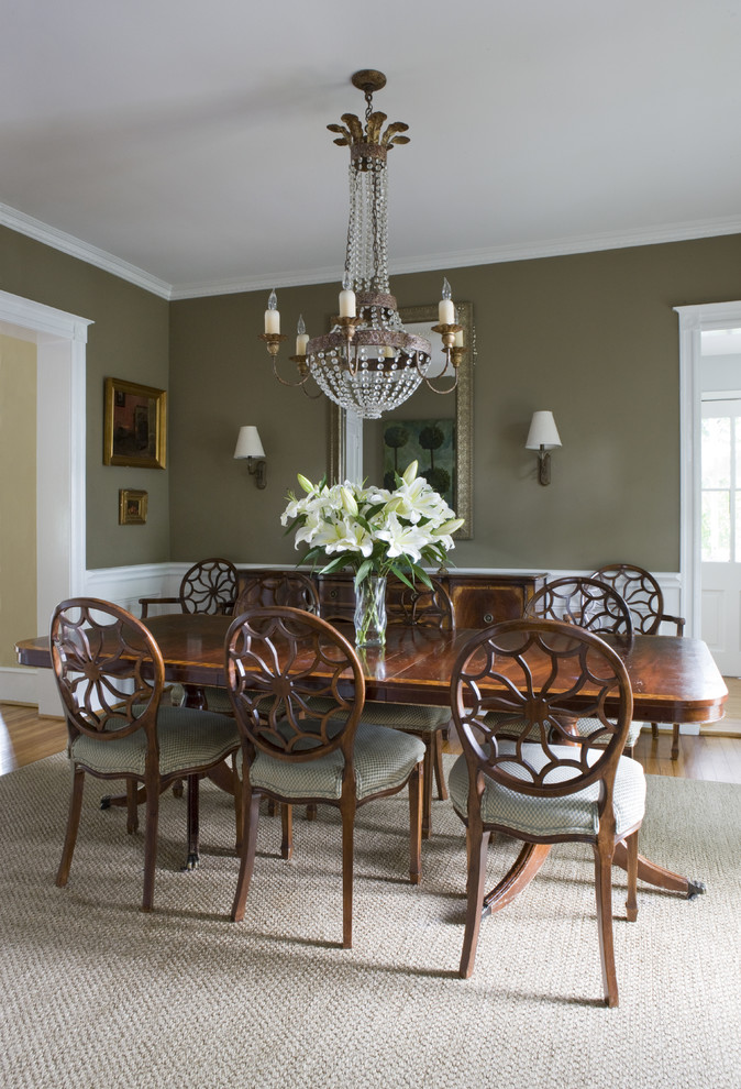 Traditional dining room in DC Metro with green walls and medium hardwood floors.