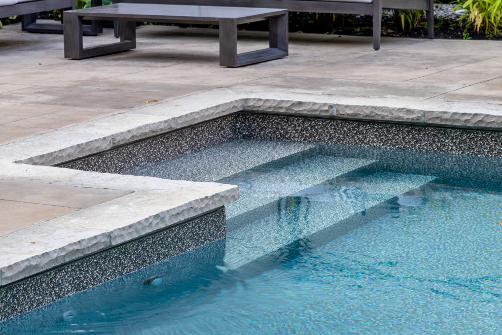 Foto di una piscina chic rettangolare di medie dimensioni e dietro casa con cemento stampato