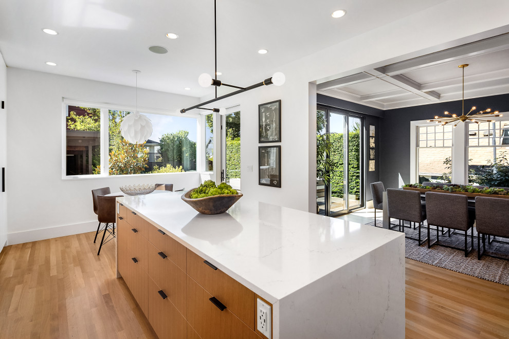 Photo of a mid-sized contemporary open plan dining in Seattle with white walls and light hardwood floors.