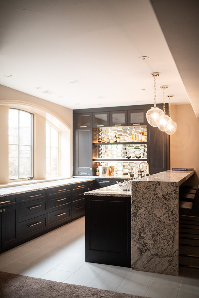 This is an example of a mid-sized contemporary u-shaped wet bar in Denver with an undermount sink, raised-panel cabinets, beige cabinets, beige floor, granite benchtops, ceramic floors and multi-coloured benchtop.