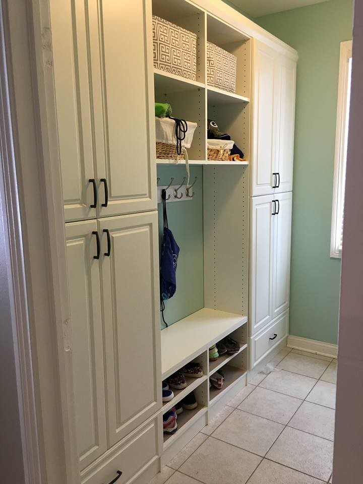 This is an example of a mid-sized traditional galley dedicated laundry room in Indianapolis with raised-panel cabinets, white cabinets, granite benchtops, an undermount sink, green walls, laminate floors, a side-by-side washer and dryer and beige floor.