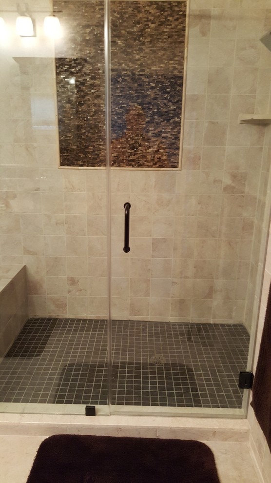 Photo of a mid-sized transitional master bathroom in New York with shaker cabinets, dark wood cabinets, a drop-in tub, a corner shower, a two-piece toilet, ceramic tile, brown walls, ceramic floors, a vessel sink, granite benchtops and a hinged shower door.