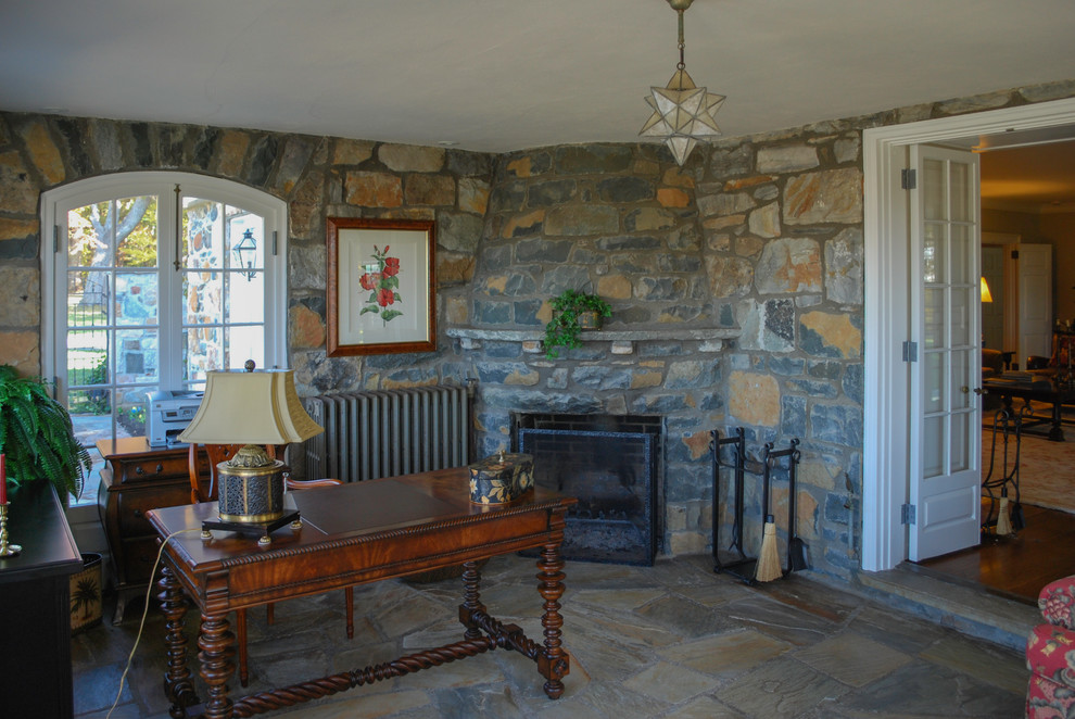 Photo of a mid-sized country home office in DC Metro with a corner fireplace, a stone fireplace surround and a freestanding desk.