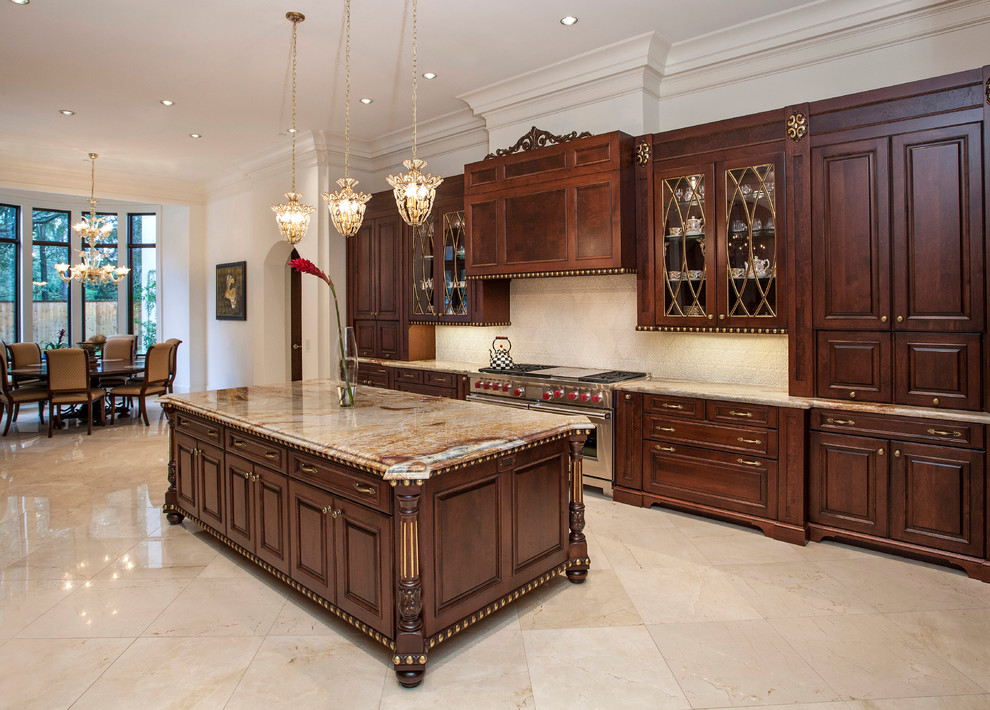 Photo of a large traditional u-shaped eat-in kitchen in Houston with raised-panel cabinets, granite benchtops, beige splashback, ceramic splashback, stainless steel appliances and with island.