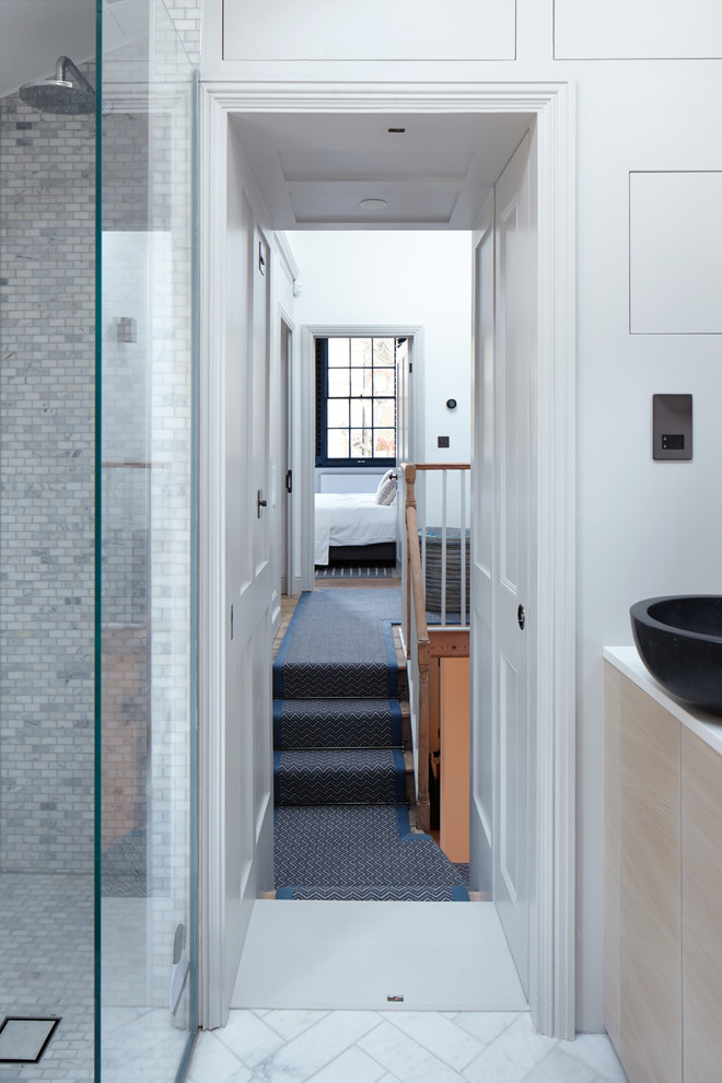 Small contemporary hallway in London with white walls and carpet.