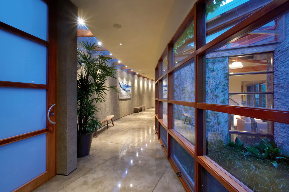 This is an example of a contemporary hallway in Orange County with concrete floors.