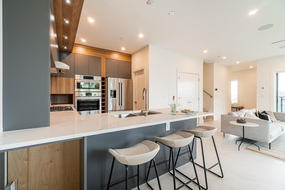Mid-sized transitional u-shaped ceramic tile and white floor kitchen pantry photo in Vancouver with an undermount sink, flat-panel cabinets, dark wood cabinets, quartzite countertops, white backsplash, ceramic backsplash, stainless steel appliances, white countertops and no island