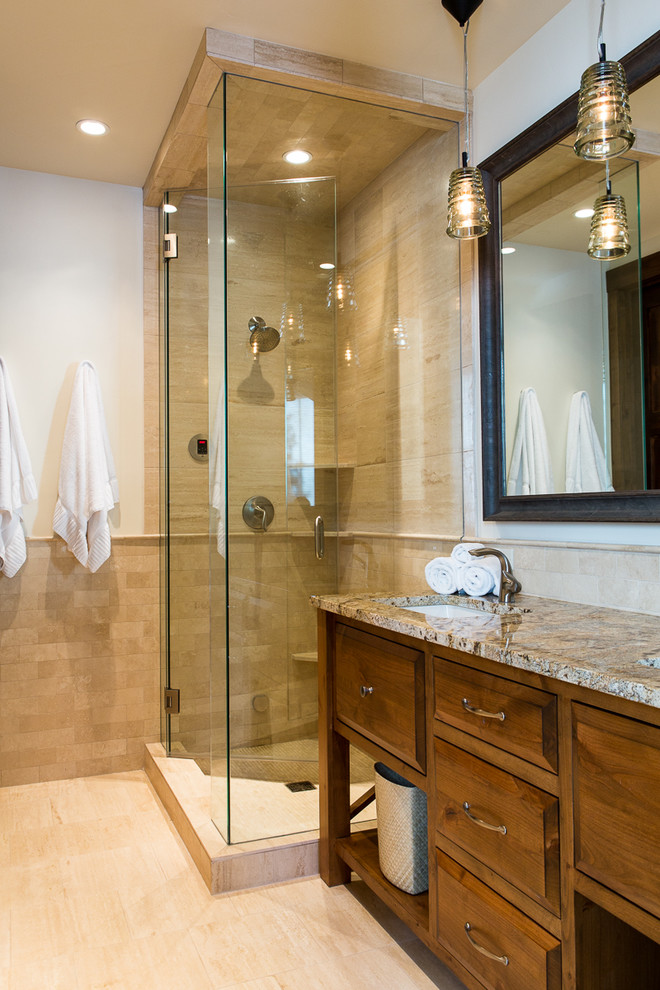 Transitional bathroom in Orange County with raised-panel cabinets, medium wood cabinets, a corner shower, beige tile, white walls, an undermount sink, beige floor, a hinged shower door and beige benchtops.