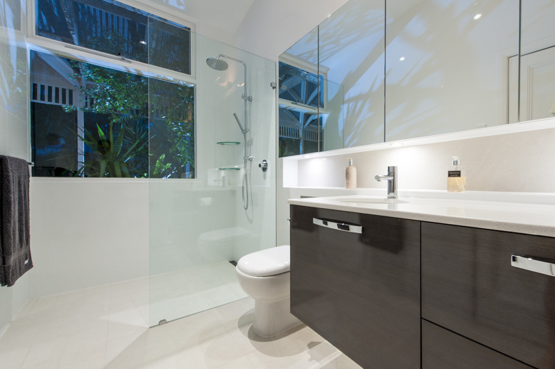 This is an example of a small modern master bathroom in Other with an undermount sink, brown cabinets, an open shower, white tile, white walls and porcelain floors.