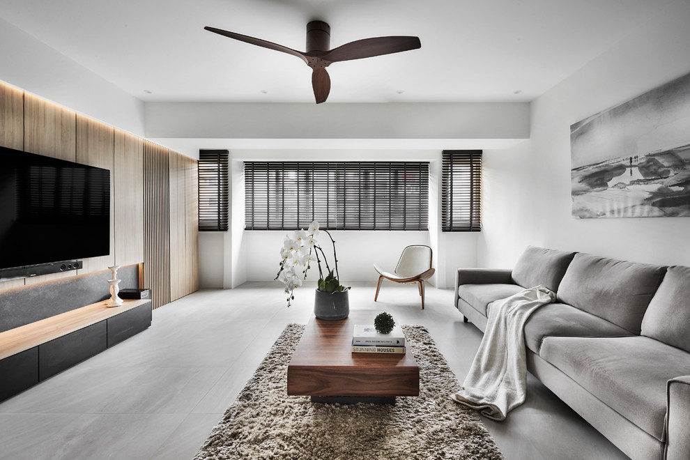 Photo of a contemporary living room in Singapore with white walls, a wall-mounted tv and grey floor.
