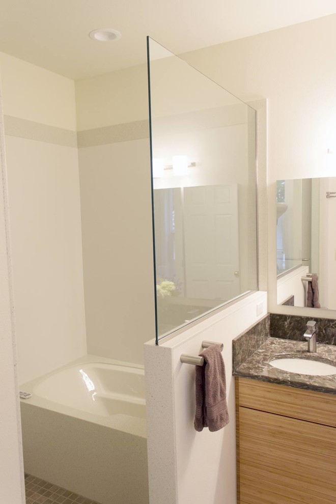 Design ideas for a mid-sized asian master wet room bathroom in Seattle with flat-panel cabinets, medium wood cabinets, an undermount tub, a one-piece toilet, white walls, linoleum floors, an undermount sink, granite benchtops, beige floor, a hinged shower door, brown benchtops, a shower seat, a double vanity and a built-in vanity.