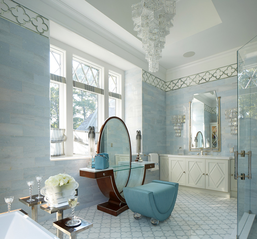 Beach style bathroom in New York with white cabinets, blue tile, white floor and a hinged shower door.