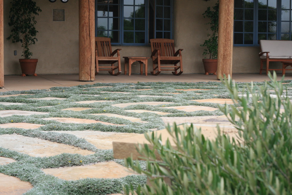 Photo of a mid-sized mediterranean backyard patio in Santa Barbara with natural stone pavers.