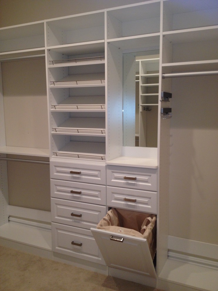 Inspiration for a large traditional gender-neutral walk-in wardrobe in Other with raised-panel cabinets, white cabinets and carpet.