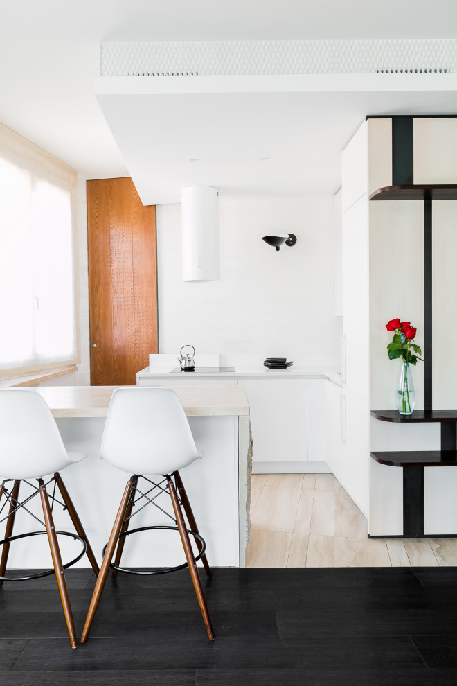 Design ideas for a small contemporary eat-in kitchen in Rome with white cabinets, white splashback, white appliances, black floor and white benchtop.