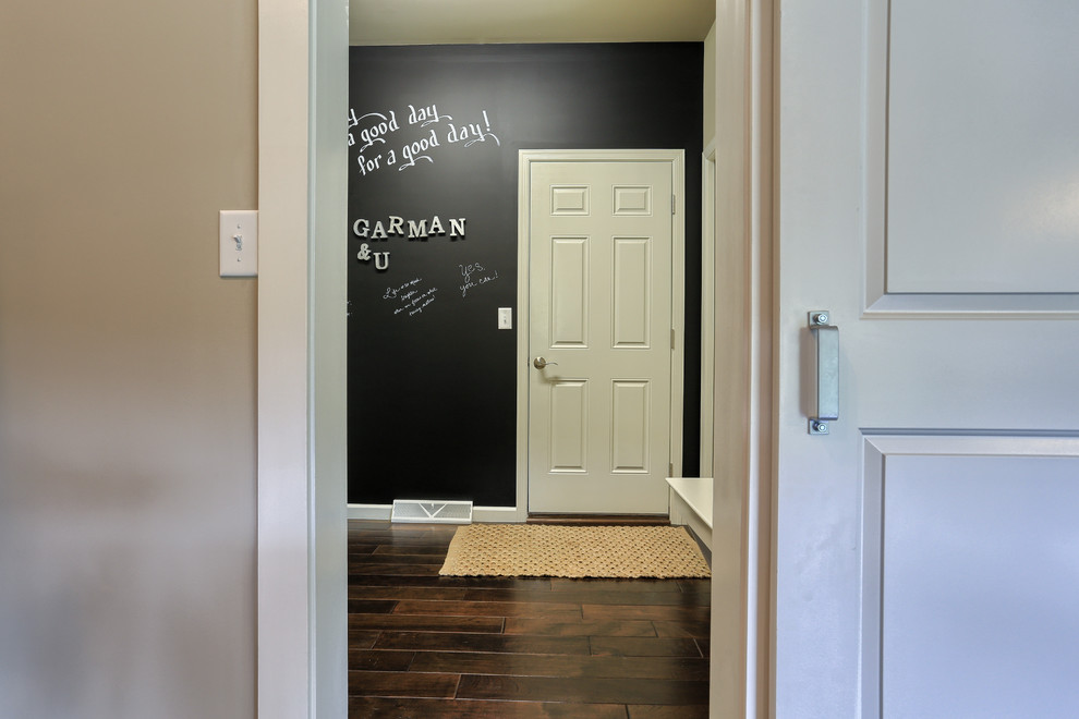 Photo of a mid-sized traditional dedicated laundry room in Other with black walls and dark hardwood floors.