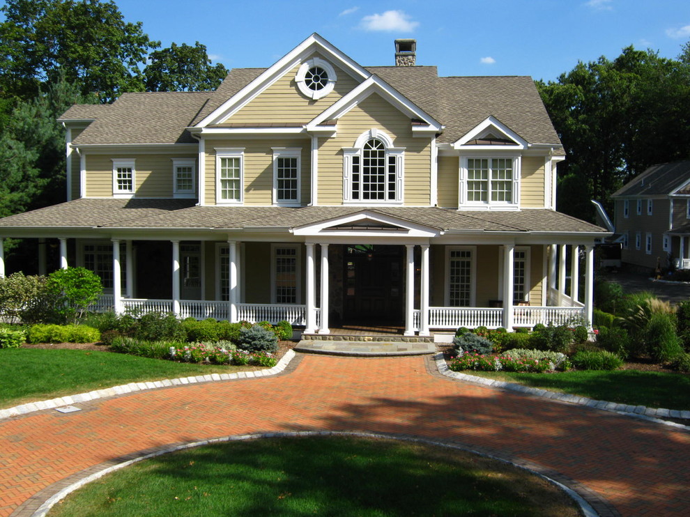 Mid-sized traditional two-storey beige exterior in New York with wood siding and a gable roof.