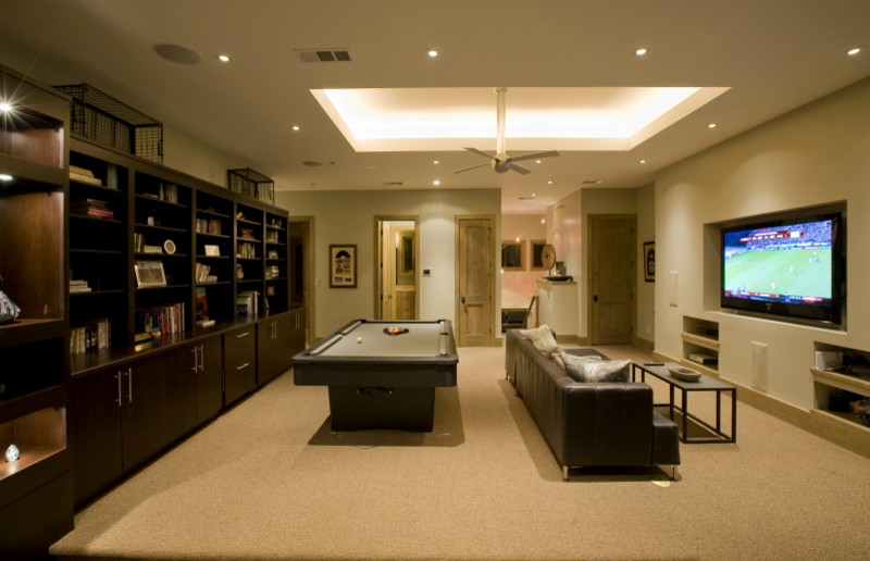 Photo of a large contemporary loft-style family room in Austin with a game room, beige walls, carpet and a built-in media wall.