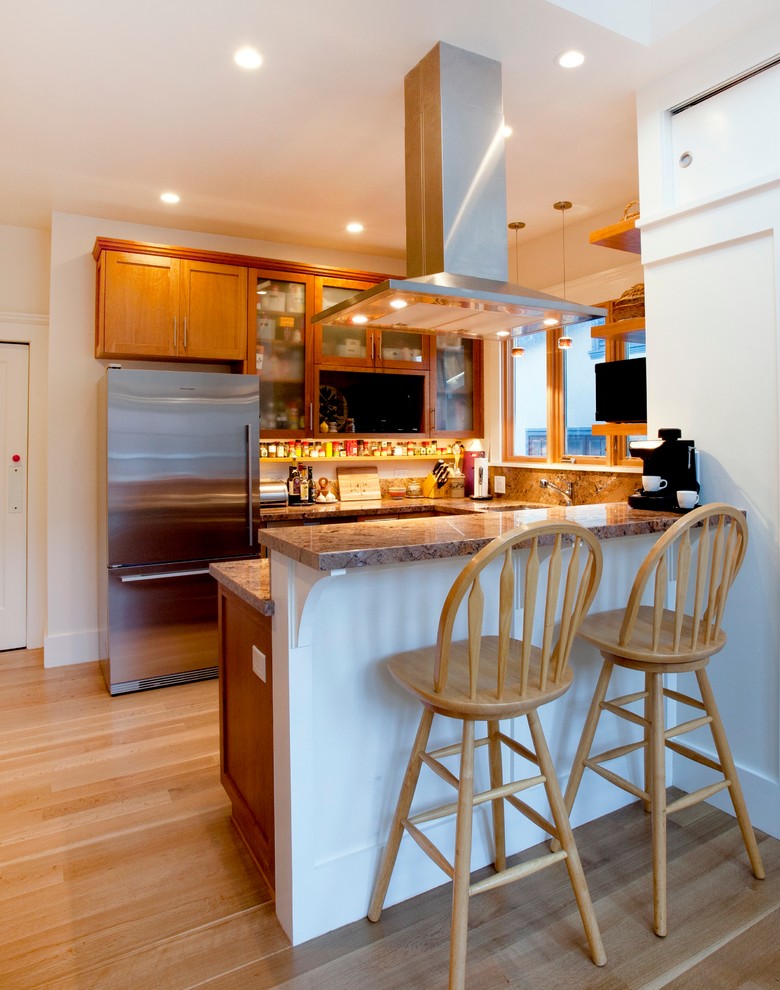 Small arts and crafts u-shaped separate kitchen in San Francisco with an undermount sink, shaker cabinets, medium wood cabinets, red splashback, stone slab splashback, stainless steel appliances, light hardwood floors, a peninsula, granite benchtops and brown floor.