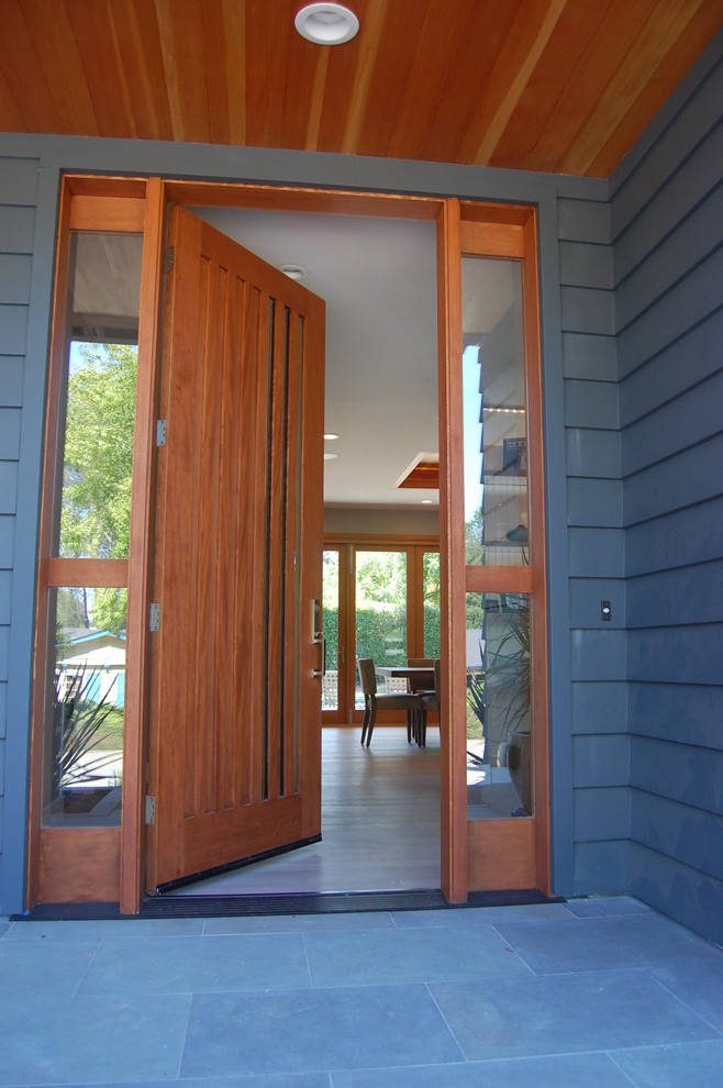 This is an example of a large contemporary front door in San Francisco with a single front door and a medium wood front door.