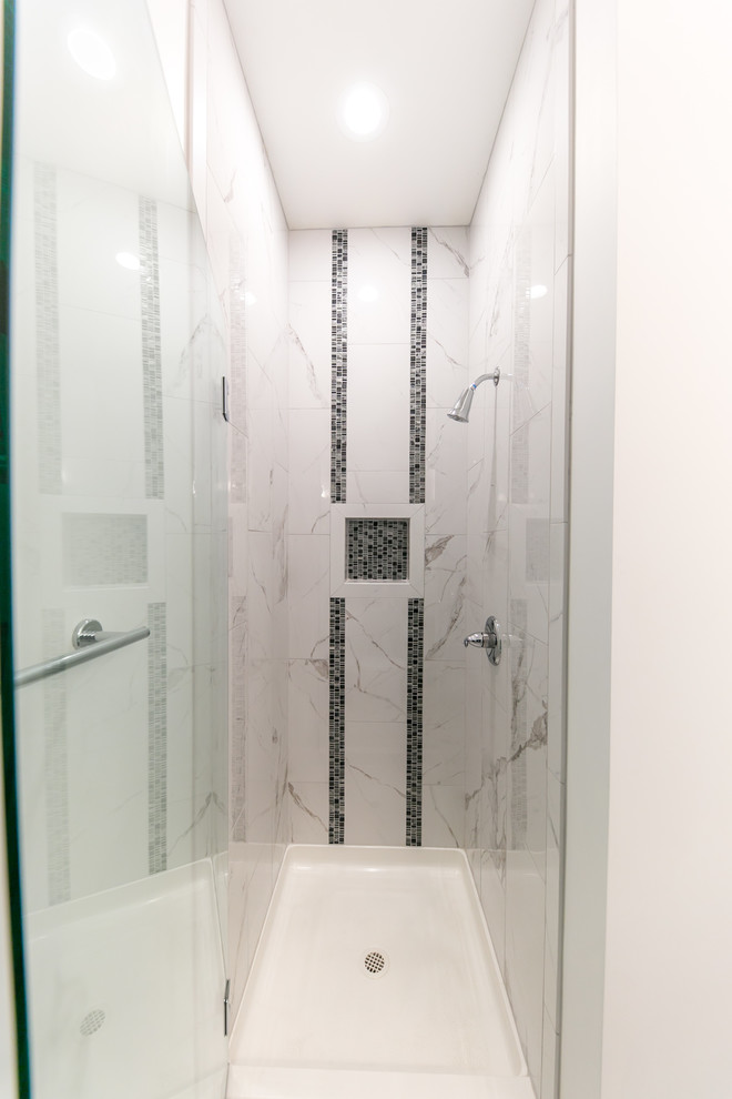 Inspiration for a mid-sized modern 3/4 bathroom in Seattle with shaker cabinets, medium wood cabinets, an alcove shower, a two-piece toilet, black and white tile, marble, grey walls, porcelain floors, an undermount sink, engineered quartz benchtops, grey floor and a hinged shower door.