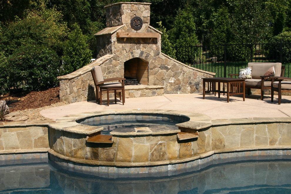 Example of a large mountain style backyard concrete paver and custom-shaped lap hot tub design in Charlotte