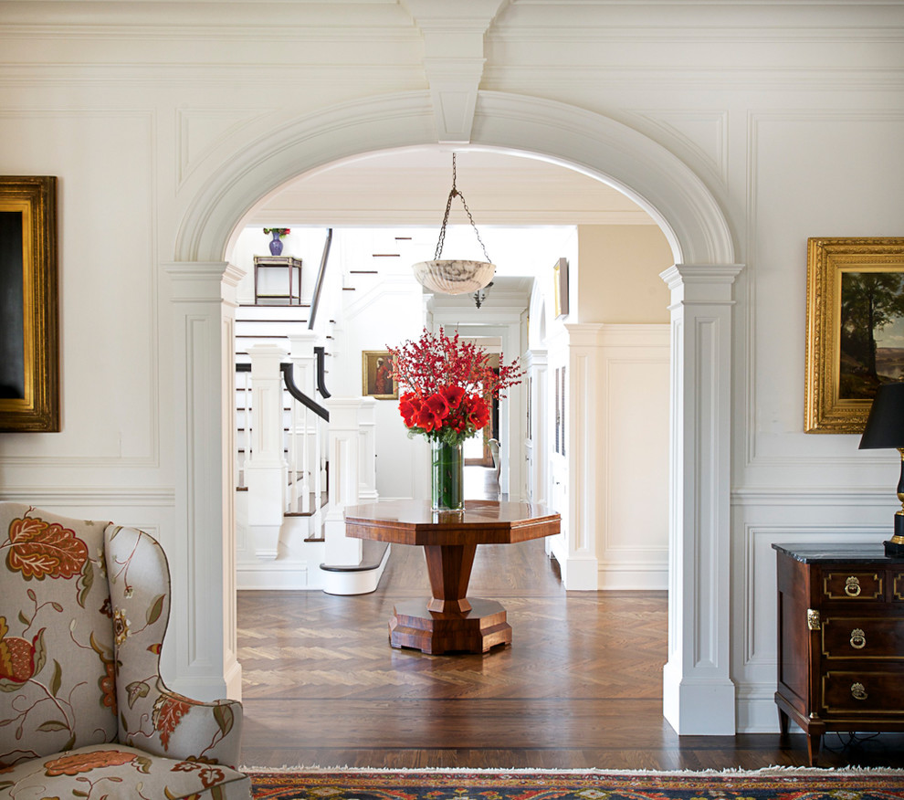 Inspiration for a traditional foyer in New York with white walls and medium hardwood floors.