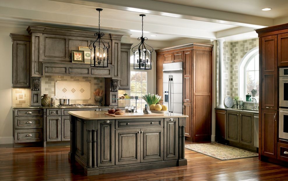 Design ideas for a mid-sized traditional kitchen in Other with raised-panel cabinets, distressed cabinets, quartz benchtops, beige splashback, ceramic splashback, stainless steel appliances, medium hardwood floors and with island.
