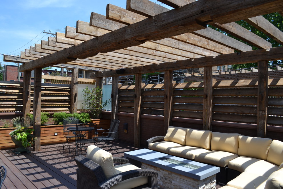 Inspiration for a large traditional rooftop deck in Chicago with a fire feature and a pergola.