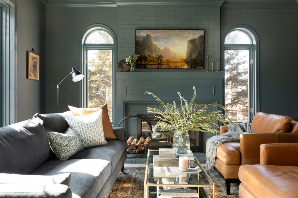 This is an example of a transitional living room in Minneapolis with green walls and a two-sided fireplace.