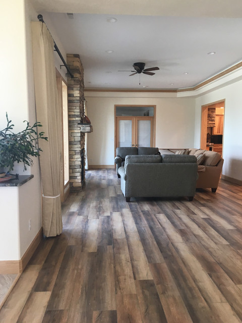 Open Family Room With Stacked Stone Two Sided Fireplace American