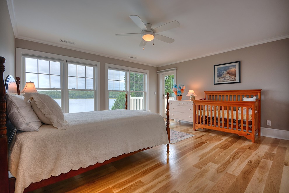 Design ideas for a large traditional master bedroom in New York with beige walls, light hardwood floors and beige floor.