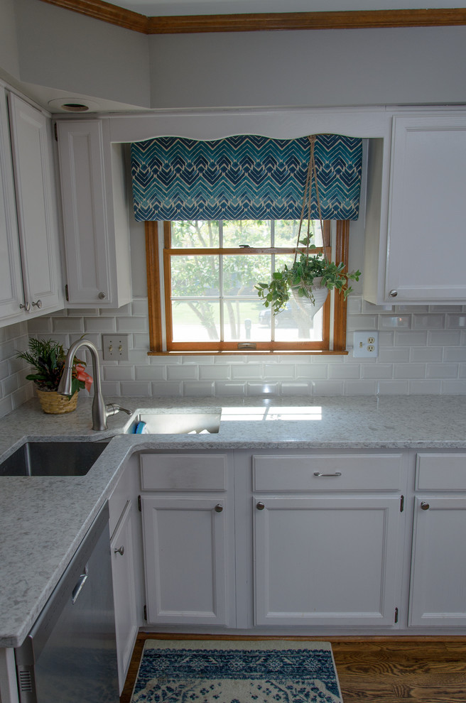Inspiration for a transitional medium tone wood floor kitchen remodel in Cincinnati with gray cabinets, quartz countertops, white backsplash, subway tile backsplash and white countertops
