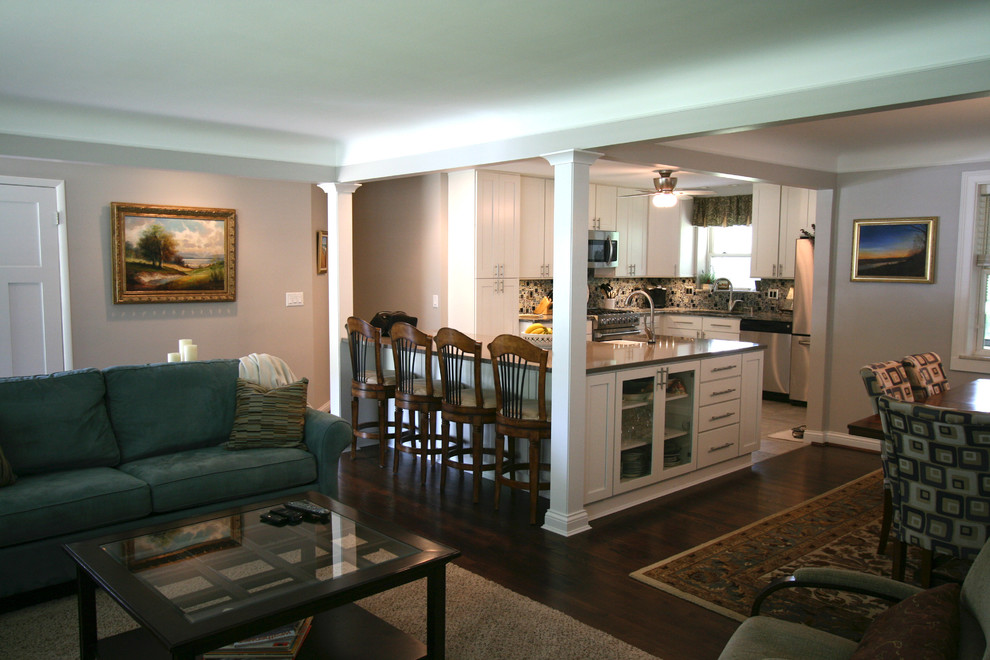 Example of a mid-sized transitional dark wood floor eat-in kitchen design in Cincinnati with a farmhouse sink, flat-panel cabinets, white cabinets, quartz countertops, multicolored backsplash, ceramic backsplash, stainless steel appliances and an island