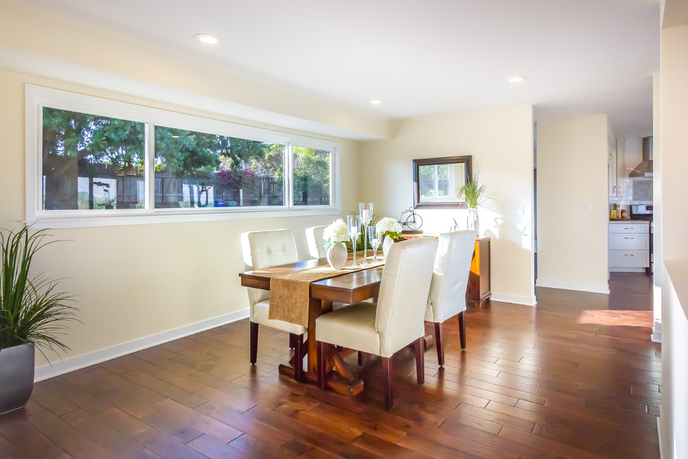 Large transitional open plan dining in San Diego with white walls and medium hardwood floors.
