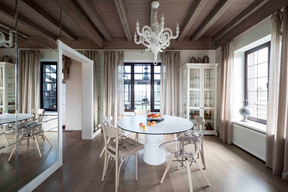 This is an example of a contemporary dining room in Moscow with white walls and medium hardwood floors.