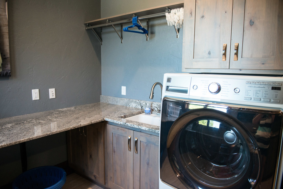 Inspiration for a huge rustic u-shaped gray floor utility room remodel with an undermount sink, flat-panel cabinets, light wood cabinets, granite countertops, blue walls, a side-by-side washer/dryer and multicolored countertops