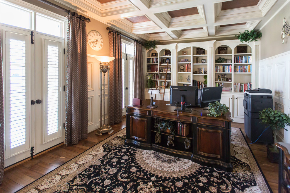 Study room - mid-sized transitional freestanding desk medium tone wood floor study room idea in Raleigh with beige walls and no fireplace