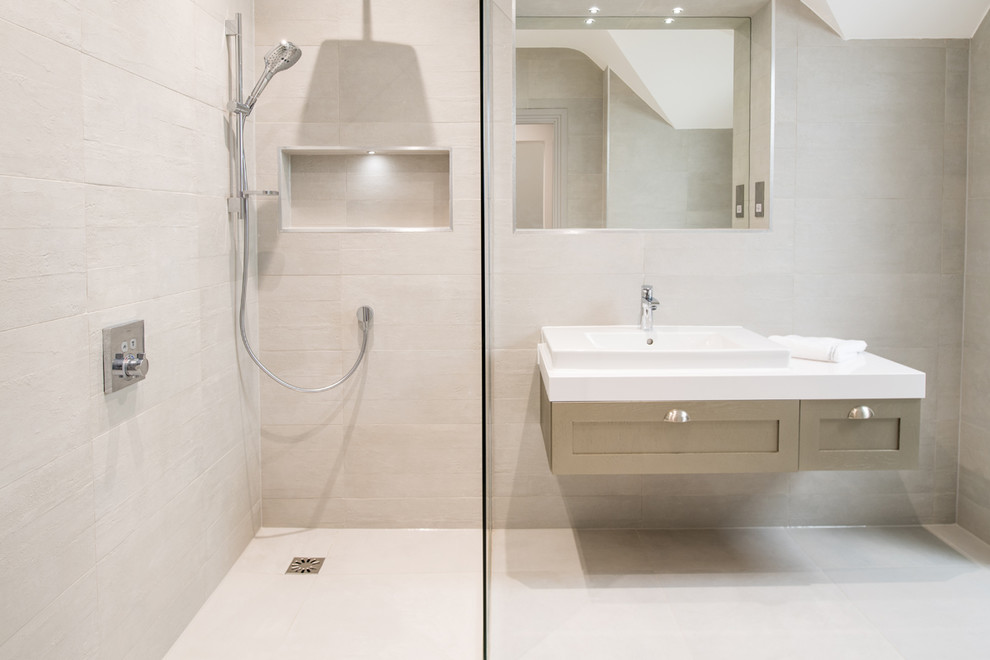 This is an example of a contemporary bathroom in London with white tile, porcelain tile, porcelain floors and white floor.